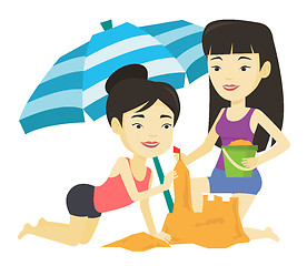 Image showing Two friends building sandcastle on beach.