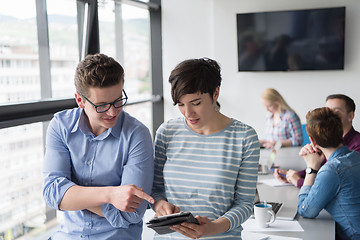 Image showing Two Business People Working With Tablet in office