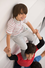 Image showing young boys posing line up piggyback top view