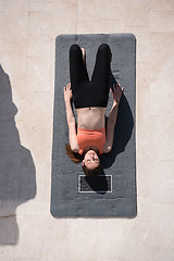 Image showing woman doing morning yoga exercises top view