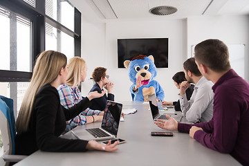 Image showing boss dresed as bear having fun with business people in trendy of