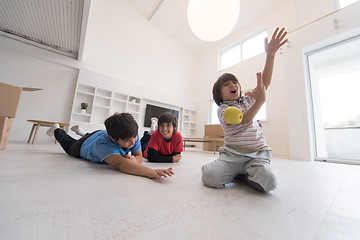 Image showing boys having fun with an apple on the floor