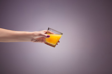 Image showing beautiful woman holding orange juice