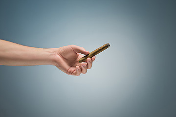 Image showing Cuban unlit cigar in male hand