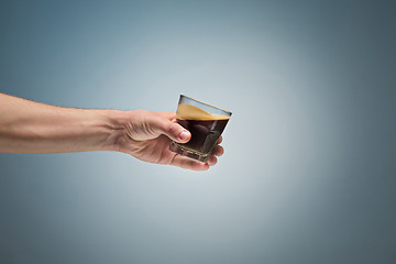 Image showing hand holding cup of coffee