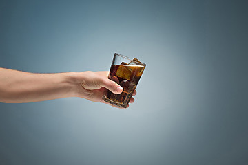 Image showing Drink cola in glass with hand