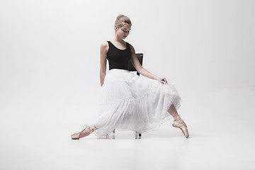 Image showing The teen ballerina in white pack sitting on chair