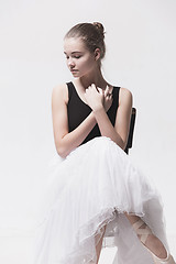 Image showing The teen ballerina in white pack sitting on chair