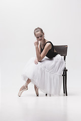 Image showing The teen ballerina in white pack sitting on chair