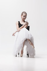 Image showing The teen ballerina in white pack sitting on chair