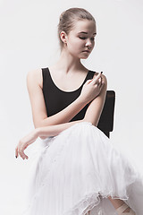 Image showing The teen ballerina in white pack sitting on chair