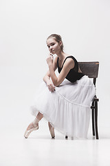 Image showing The teen ballerina in white pack sitting on chair