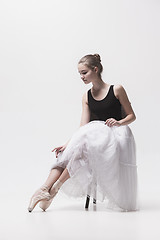 Image showing The teen ballerina in white pack sitting on chair