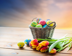 Image showing close up of easter eggs in basket and flowers