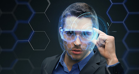 Image showing businessman in 3d glasses with virtual hologram