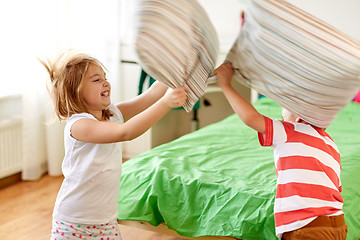 Image showing kids playing and fighting by pillows at home