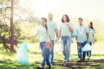 Image showing group of volunteers with garbage bags in park