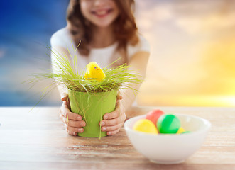 Image showing close up of girl with easter toy chicken and eggs