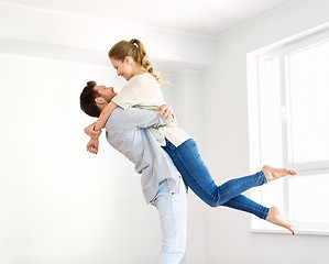 Image showing happy couple at empty room of new home