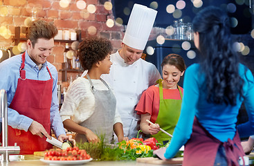 Image showing happy friends and chef cook cooking in kitchen