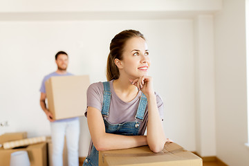 Image showing happy couple with boxes moving to new home