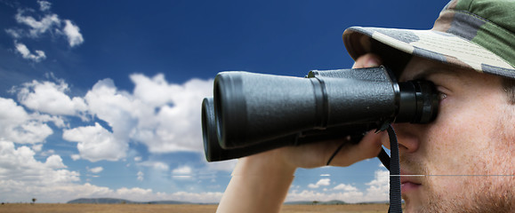 Image showing close up of soldier face looking to binocular