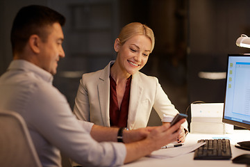 Image showing business people with smartphone at night office