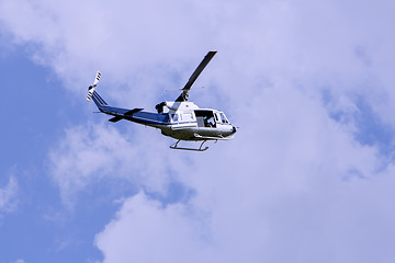 Image showing Blue helicopter flight in the sky