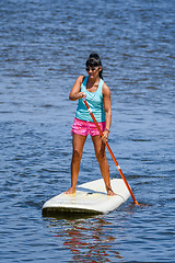 Image showing Woman stand up paddleboarding
