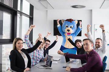 Image showing boss dresed as bear having fun with business people in trendy of