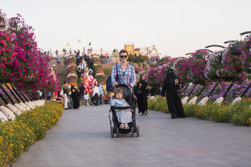 Image showing mother and daughter in flower garden