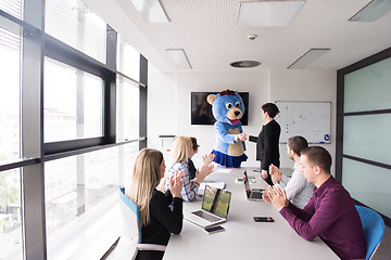 Image showing boss dresed as bear having fun with business people in trendy of