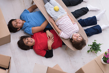 Image showing boys with cardboard boxes around them top view