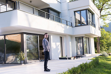 Image showing man in front of his luxury home villa