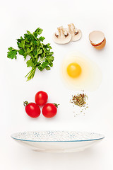 Image showing The falling ingredients of fried egg. Healthy breakfast ingredients.