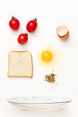 Image showing The falling ingredients of fried egg. Healthy breakfast ingredients.