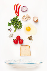 Image showing The falling ingredients of fried egg. Healthy breakfast ingredients.