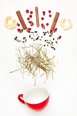 Image showing Beautiful and delicious dried tea leaves with herbs, flowers, berries, fruits, coconut slices, cocoa and coffee chips. Detailed studio shoot with selective focus and abstract blurred background