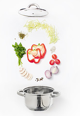 Image showing Assorted fresh vegetables falling into a bowl, on white background