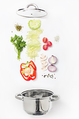 Image showing Assorted fresh vegetables falling into a bowl, on white background