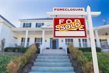 Image showing Left Facing Foreclosure Sold For Sale Real Estate Sign in Front 