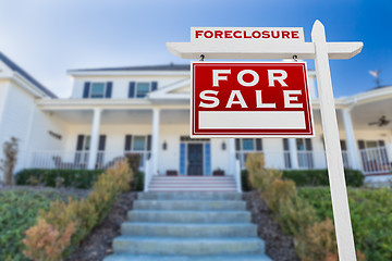 Image showing Left Facing Foreclosure For Sale Real Estate Sign in Front of Ho