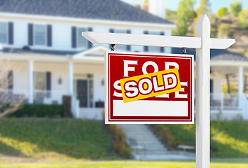 Image showing Left Facing Sold For Sale Real Estate Sign In Front of House.