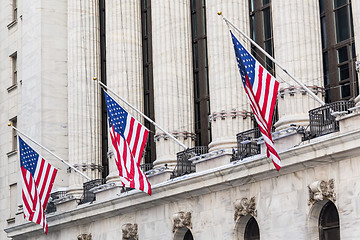 Image showing American flags waving on exterior of New york Stock Exchange, Wall street, lower Manhattan, New York City, USA.