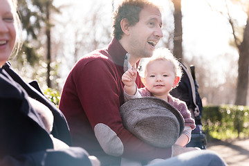 Image showing Young family with cheerful child in the park.