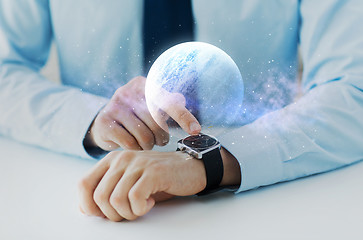 Image showing hands with planet hologram over smart watch