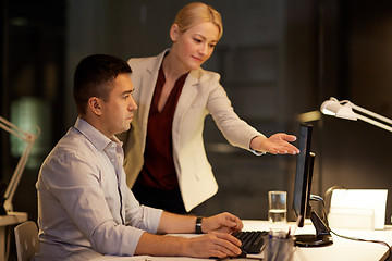 Image showing business team with computer working late at office