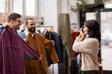 Image showing friends photographing at vintage clothing store