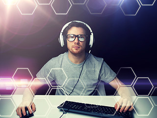 Image showing man in headset computer over hexagons projection