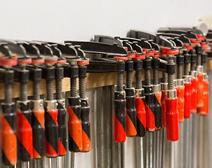 Image showing one-handed bar clamps hanging on wall